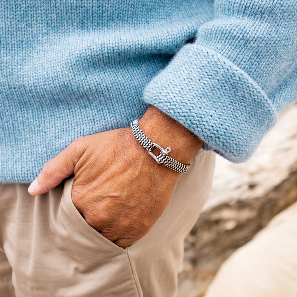 Photo lifestyle Bracelet beige et bleu tréssé avec des cordages de bateau recyclé. Bracelet Vicious Vik beige et bleu de Pig and Hen. Corde de bateau recyclé tréssé fini avec un fermoir manille. Tendance lifestyle pour homme chez Robin concept store masculin, boutique en ligne de cadeau pour homme.